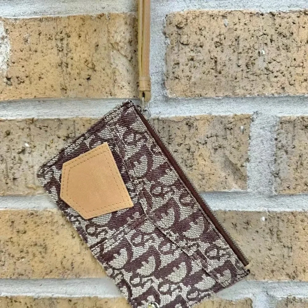 Christian Dior monogram wristlet. Comes with copy of COA from Entrupy